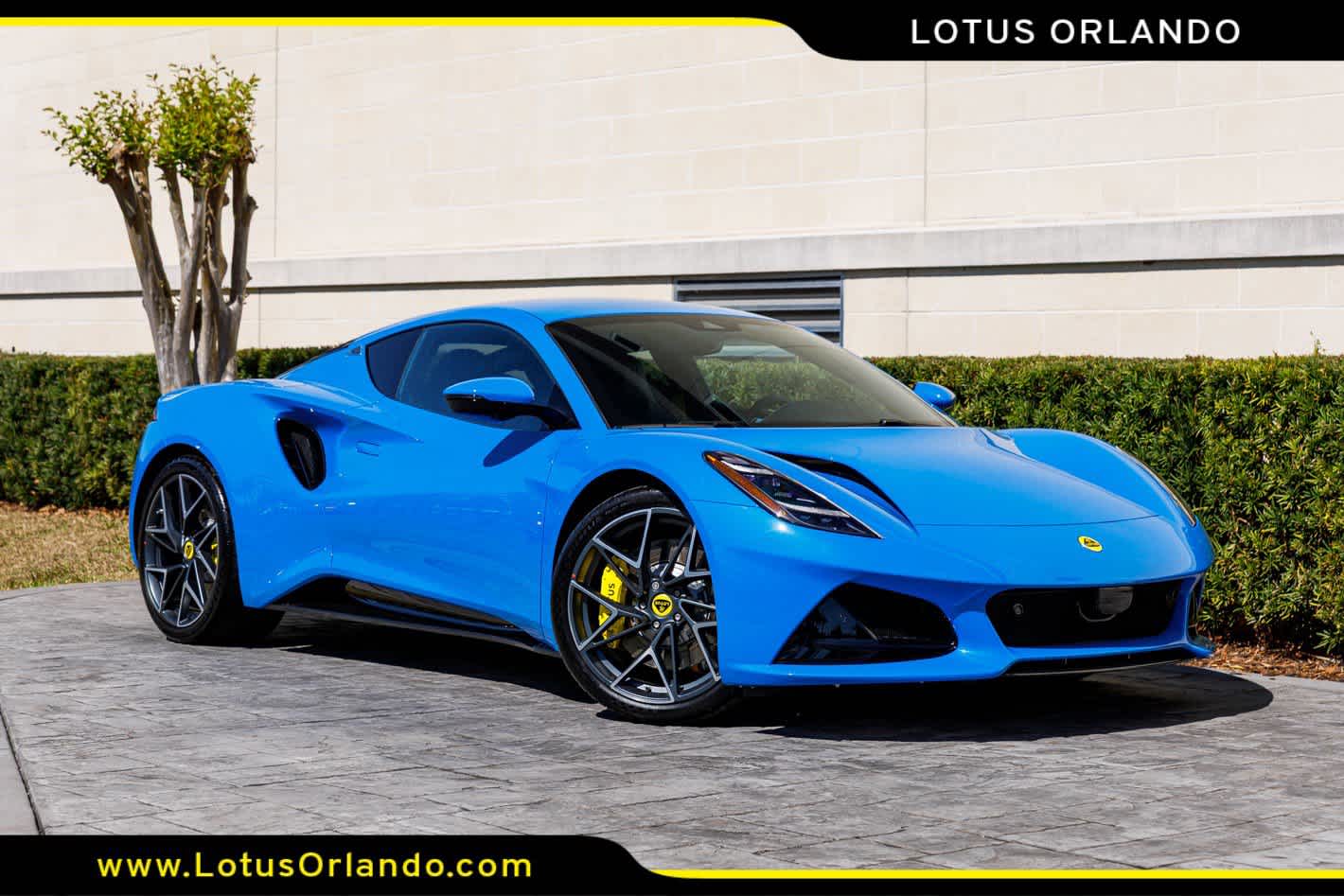 2026 Lotus Emira V6 SE in Seneca Blue — front three-quarter view